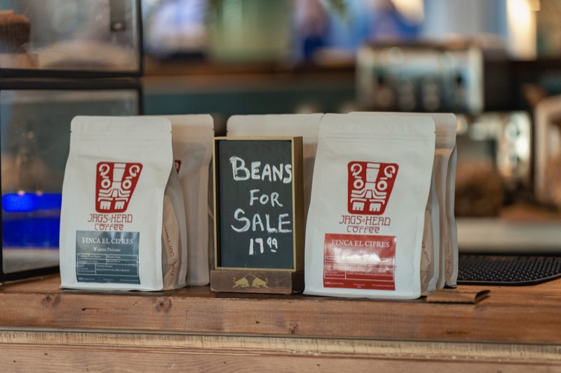 Bags of locally roasted coffee beans for sale at Crane Coffee